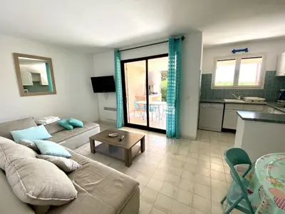 a living room with a couch and a table at Mini-villa Bocca del Oro - Sud Porto-Vecchio in Bocca del Oro