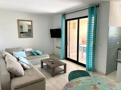 a living room with a couch and a table at Mini-villa Bocca del Oro - Sud Porto-Vecchio in Bocca del Oro