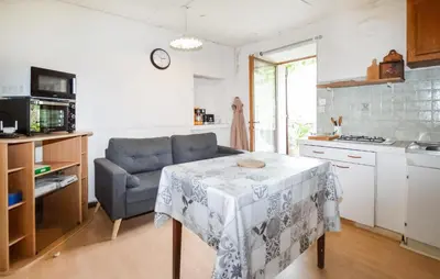 a kitchen with a table and a chair in a kitchen at Nice Apartment In Sant Andrea Di Bozio in Sant Andrea di Bozio