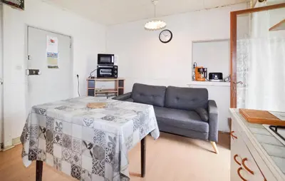 a living room with a table and a couch at Nice Apartment In Sant Andrea Di Bozio in Sant Andrea di Bozio
