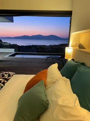a bedroom with a bed with a view of the ocean at Villa vue mer piscine in Pietrosella