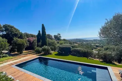 a swimming pool in the middle of a garden with trees at Villa A Muvra Di Pinarellu in Pinarellu