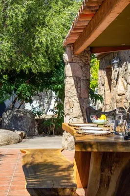 a stone table with a bowl of fruit on it at Casa Isabella Di Santa Lucia in Sainte-Lucie de Porto-Vecchio
