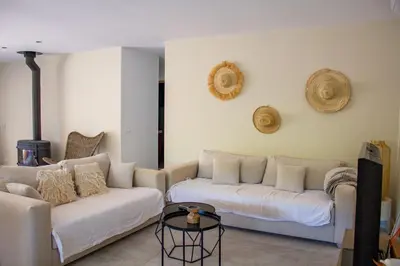 a living room with two white couches and a table at Casa Isabella Di Santa Lucia in Sainte-Lucie de Porto-Vecchio