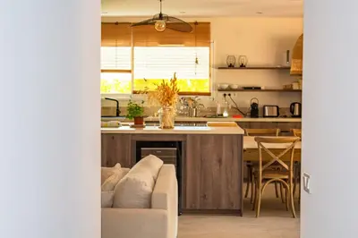 a living room with a couch and a kitchen at Casa Isabella Di Santa Lucia in Sainte-Lucie de Porto-Vecchio