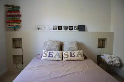 a bedroom with a bed with two pillows on it at Casa Isabella Di Santa Lucia in Sainte-Lucie de Porto-Vecchio
