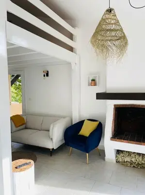 a living room with a couch and a fireplace at Mini villa agosta plage in Albitreccia