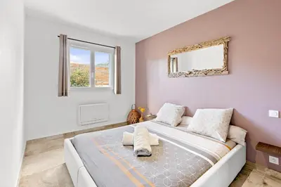 a bedroom with a bed and a mirror on the wall at Villa Mara in Lecci