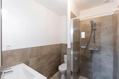 a bathroom with a shower with a toilet and a sink at Villa Mara in Lecci