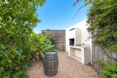 a barrel is sitting next to a fence at Villa Mara in Lecci