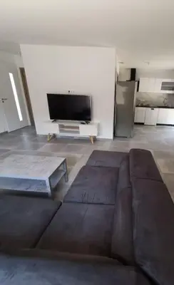 a living room with a couch and a tv at Villa t4 in Lucciana