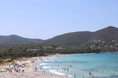 a group of people on a beach in the water at A Rundinella in Grosseto-Prugna