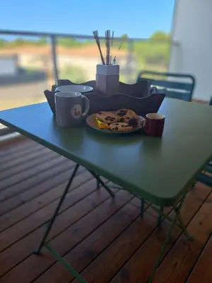 a table with a plate of food and cups on it at A Rundinella in Grosseto-Prugna