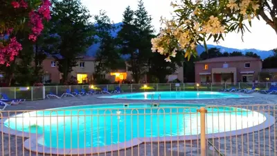 a large swimming pool with blue water at Appartement Corse in Santa-Maria-Poggio