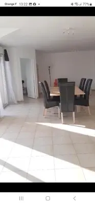 a dining room with a table and black chairs at Appartement Corse in Santa-Maria-Poggio