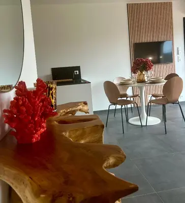 a dining room with a table and a table and chairs at À Casetta Porticcio Spacieux T2 50m2 Neuf Terrasse & Jardin privatif à 3min des plus belles plages in Porticcio