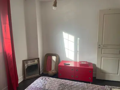 a bedroom with a red dresser and a mirror at Cœur de la corse niolo in Albertacce