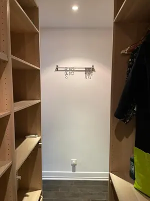 a walk in closet with a closet door with a shelf at Cœur de la corse niolo in Albertacce