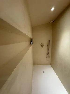 a small room with a phone on the wall at Charmante maison en pierre vue mer et piscine privée in Cuttoli-Corticchiato