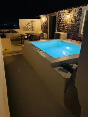 a swimming pool in the middle of a patio at night at Charmante maison en pierre vue mer et piscine privée in Cuttoli-Corticchiato