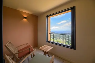a room with a window with chairs and a table at Le Belvedere in Lavatoggio