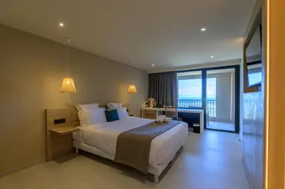 a bedroom with a large bed and a large window at Le Belvedere in Lavatoggio