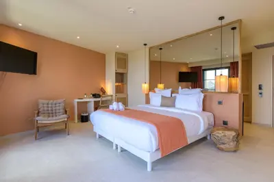 a large bedroom with a large bed and a desk at Le Belvedere in Lavatoggio
