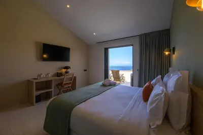 a bedroom with a bed with a view of the ocean at Le Belvedere in Lavatoggio