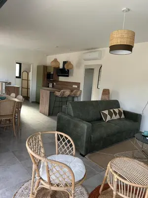 a living room with a green couch and chairs at Casa Corsu Villa avec piscine in Figari