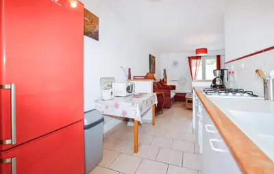 a kitchen with a red refrigerator and a counter top at Lovely Home In Vignale With Wifi in Vignale
