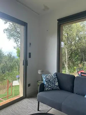 a living room with a couch and a sliding glass door at Casaty Mare in Porto-Vecchio