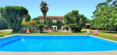 a swimming pool in front of a house at La Casalamadonna in Santa-Lucia-di-Moriani