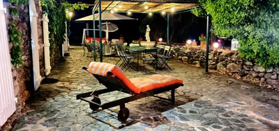 an orange chair sitting on a stone patio at night at La Casalamadonna in Santa-Lucia-di-Moriani