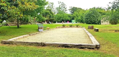 a park with a bench in the middle of a field at La Casalamadonna in Santa-Lucia-di-Moriani