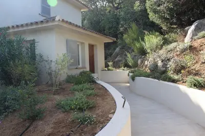 a house with a walkway in front of a yard at Villa ALPANNA in Cirendinu