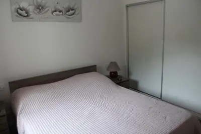 a bedroom with a bed with a white bedspread at Villa ALPANNA in Cirendinu