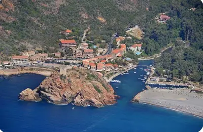 a view of a town with mountains in the background at Appartement maison de village à Ota-Porto in Porto Ota