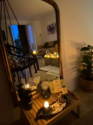 a mirror reflection of a living room with a table with candles at I pozzi jacuzzi furiani love room haute corse in Furiani