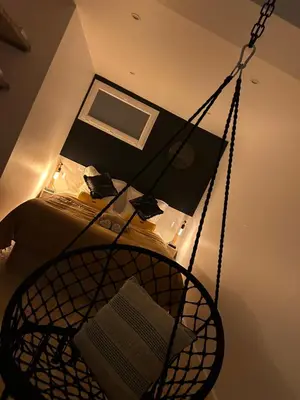 a room with a hammock in front of a bed at I pozzi jacuzzi furiani love room haute corse in Furiani