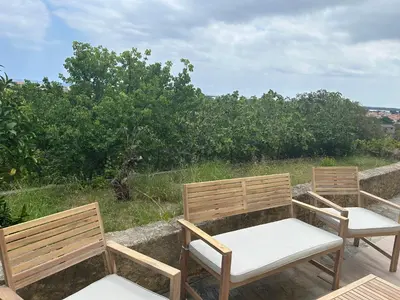 a couple of chairs sitting on top of a deck at I pozzi jacuzzi furiani love room haute corse in Furiani
