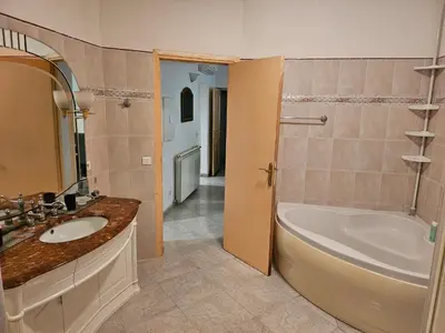 a bathroom with a tub and a sink and a bath tub at Villa des fleurs in Ortale