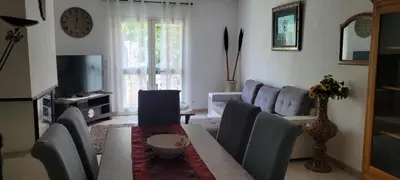 a living room with a couch and a table at Villa des fleurs in Ortale