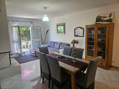 a living room with a table and a couch at Villa des fleurs in Ortale