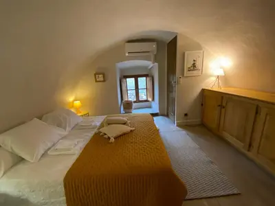a bedroom with a large bed and a window at La Casetta in Castifao