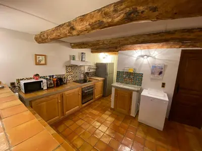 a large kitchen with wooden cabinets and appliances at La Casetta in Castifao