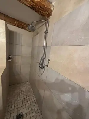 a shower stall in a bathroom with a tile floor at La Casetta in Castifao