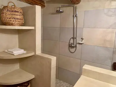a bathroom with a shower with a sink and a toilet at La Casetta in Castifao