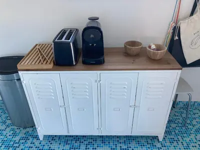a white cabinet with a toaster on top of it at Duplex terrasse vue mer in Pisinale
