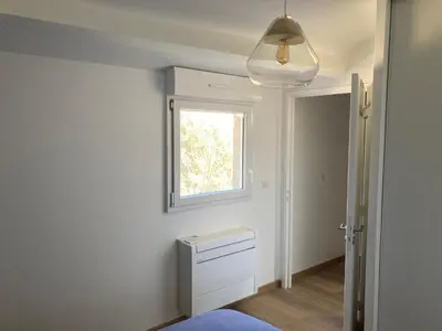 a bedroom with a window and a bed in a room at Duplex terrasse vue mer in Pisinale