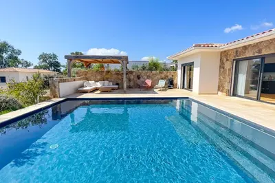 a swimming pool in the backyard of a house at Villa A Calia di Fiori Mare in Sainte-Lucie de Porto-Vecchio